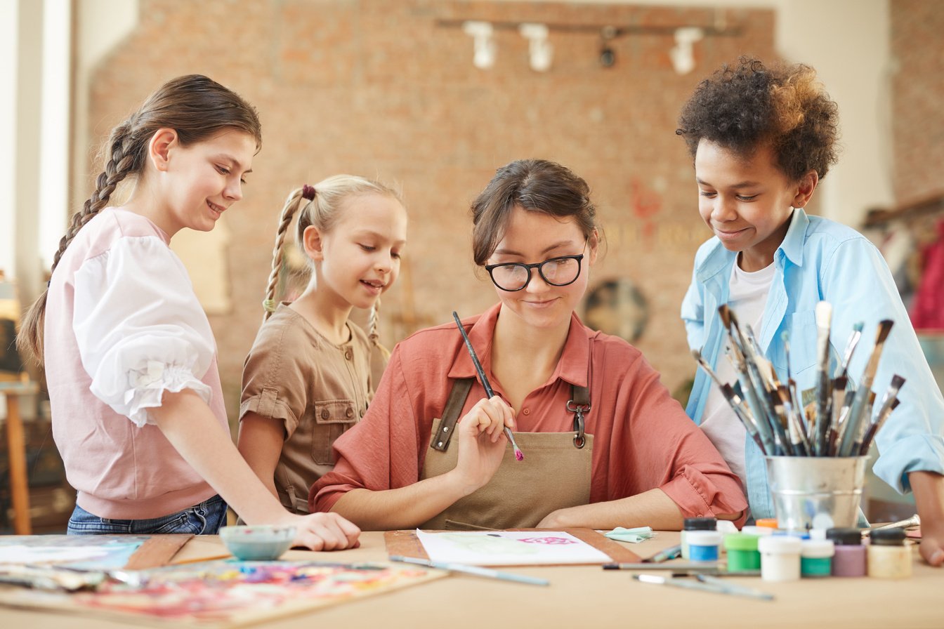 Teacher with Students Sitting at Art Studio